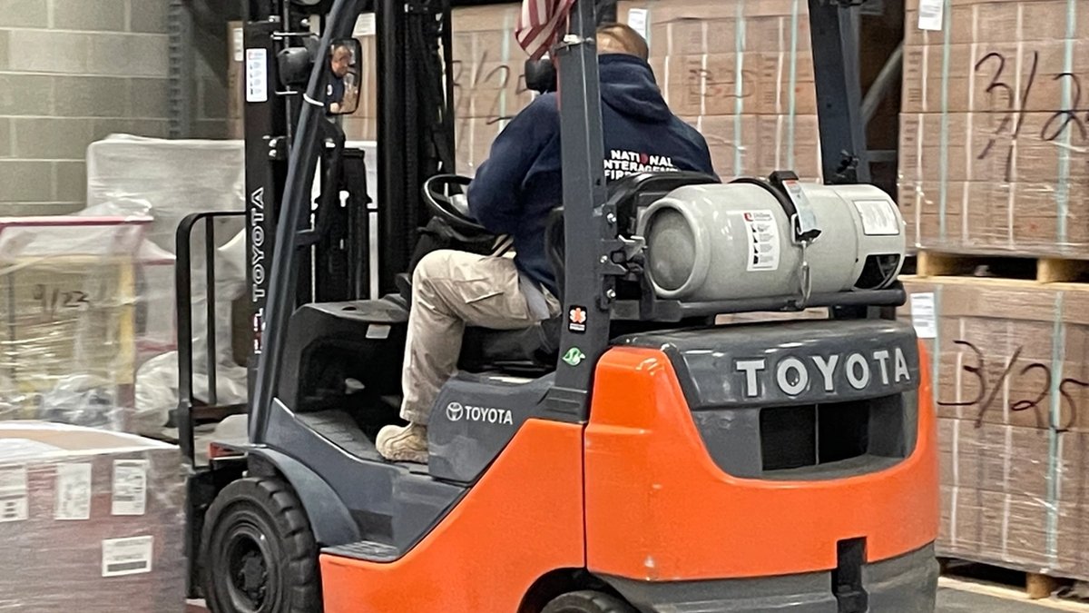 Forklift moving boxes inside the warehouse
